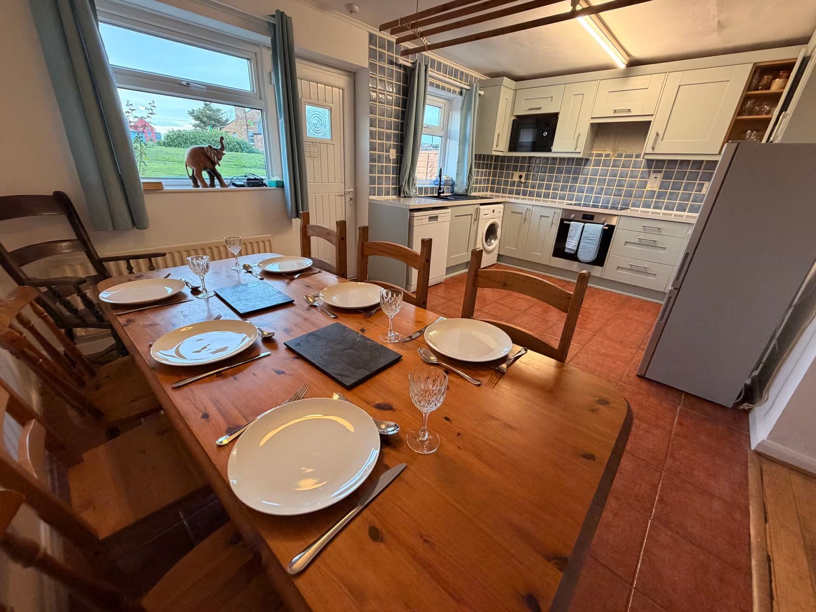 Dining table and open-plan kitchen