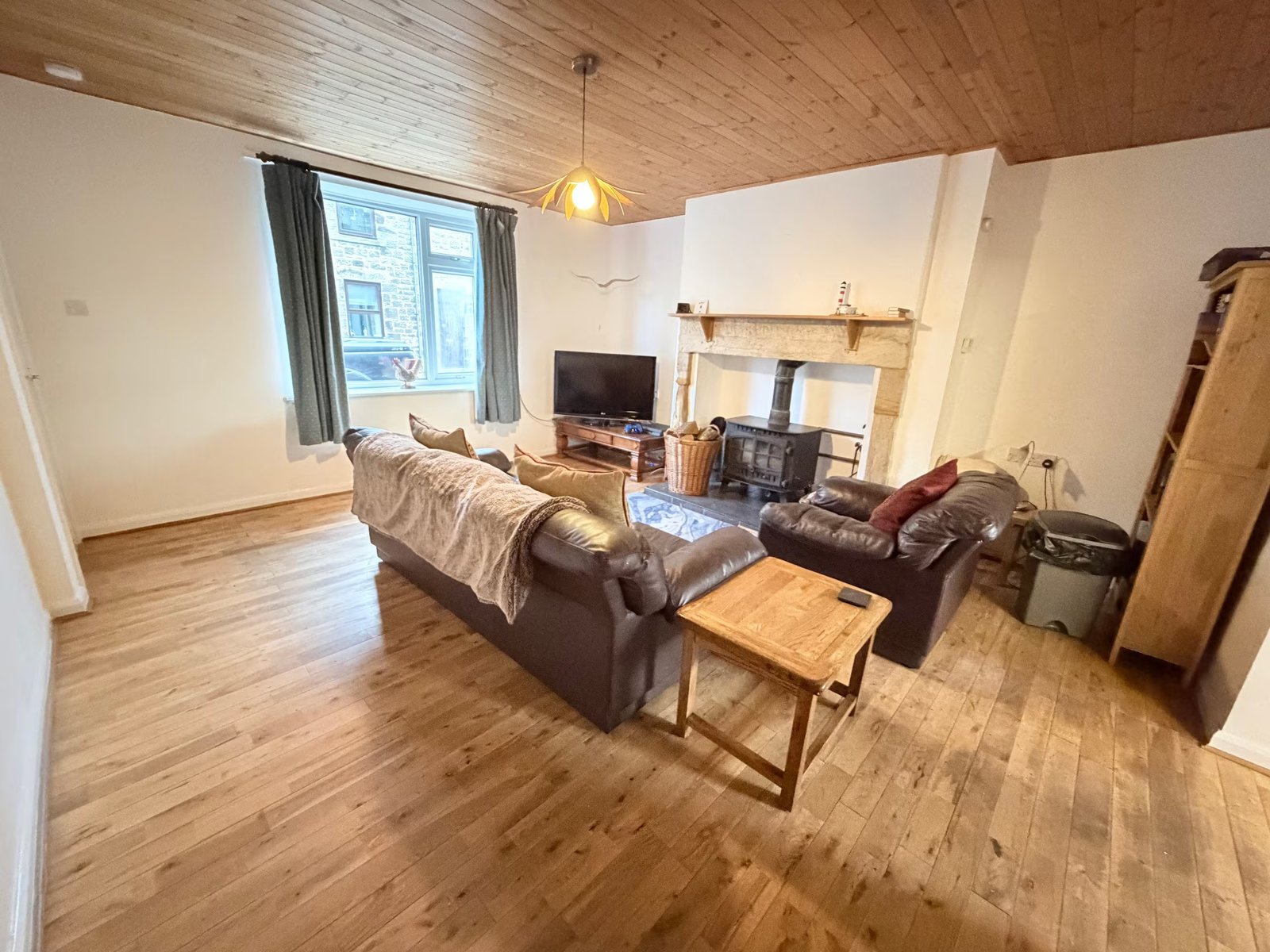 Living room with wood-burning stove at SpaHome’s By The Beach
